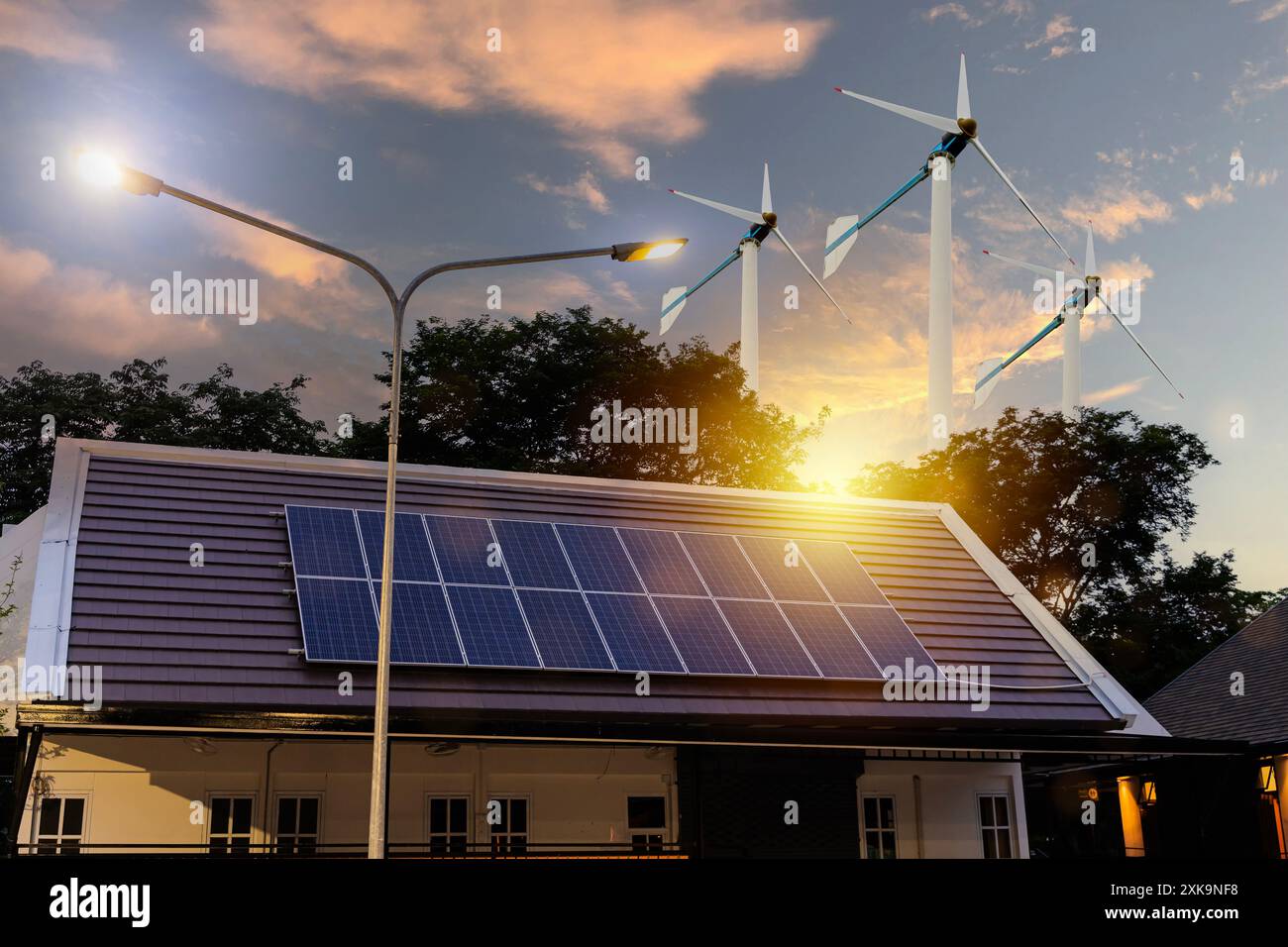 Solar panels on the house roof and wind turbines surround it. the ...