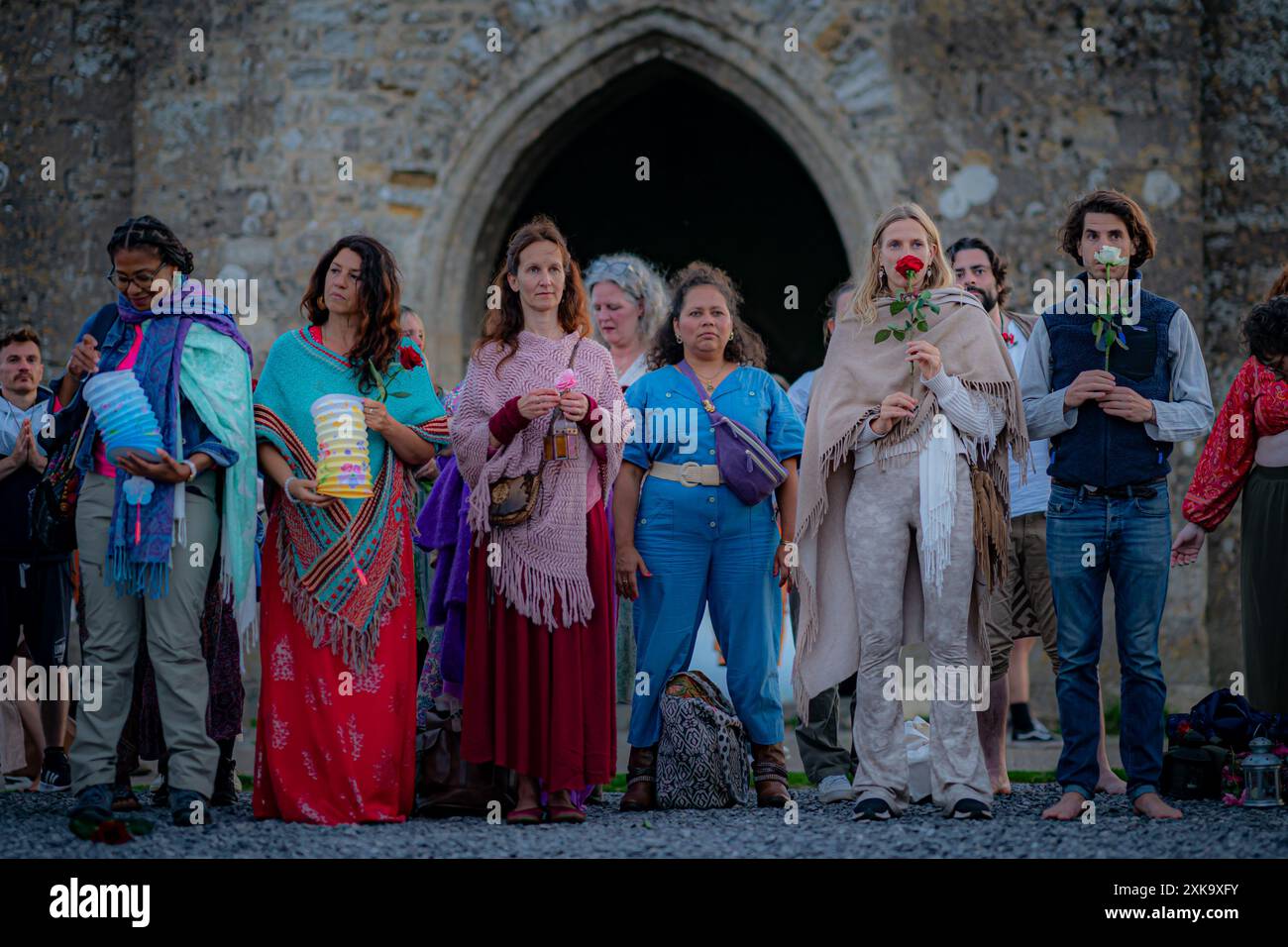 People hold roses on the pilgrimage of light, during the Sacred ...