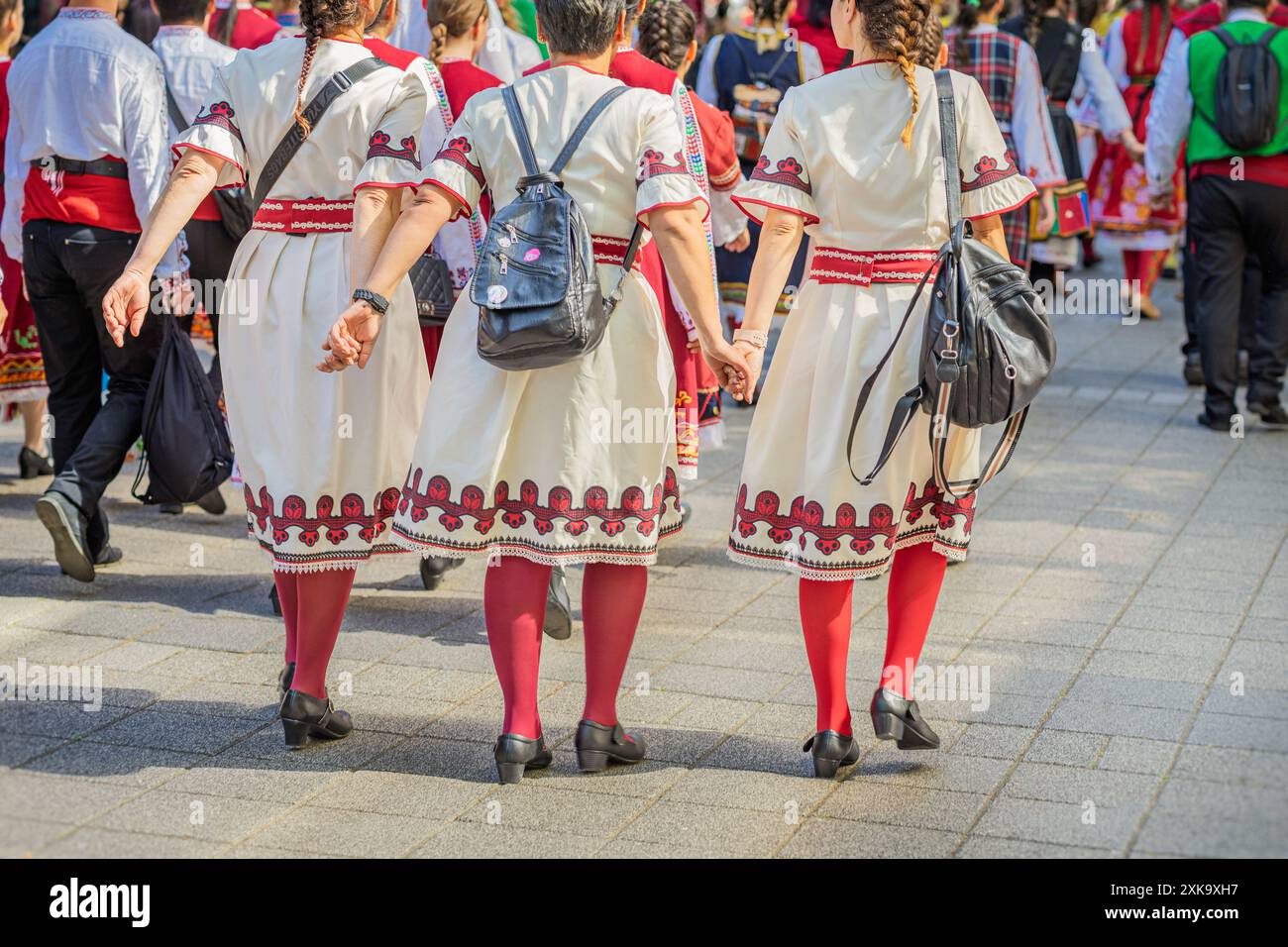 Bulgarian Women in Traditional Folk Clothing Walking Through a City Stock Photo