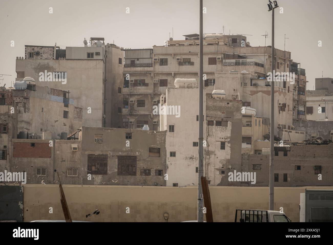 The old building in residential areas of Jeddah, Saudi Arabia, with trash and piles of rubbish and garbage in polluted poor areas. Stock Photo