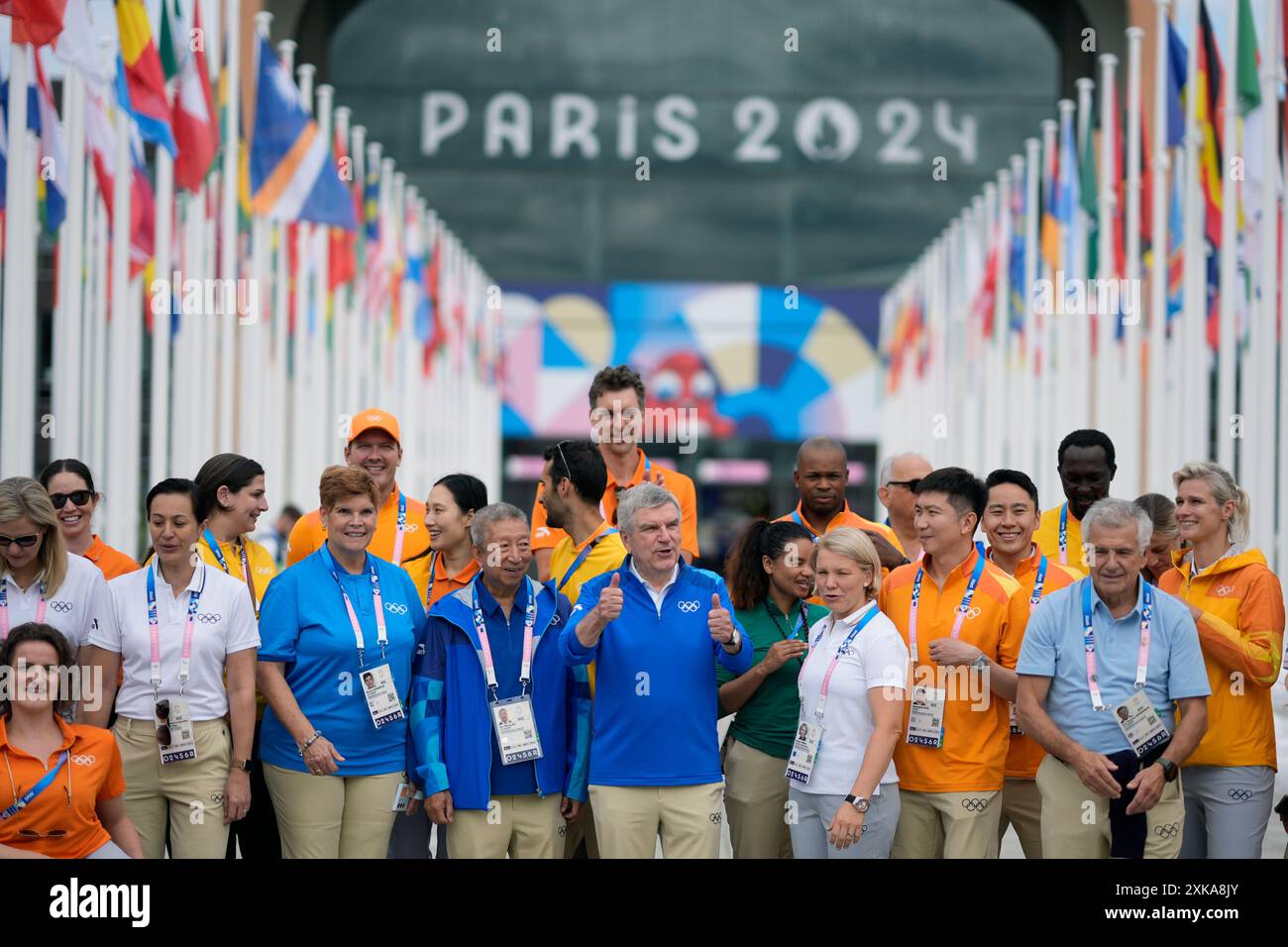 IOC President Thomas Bach gives a thumbs up while taking a photo with ...