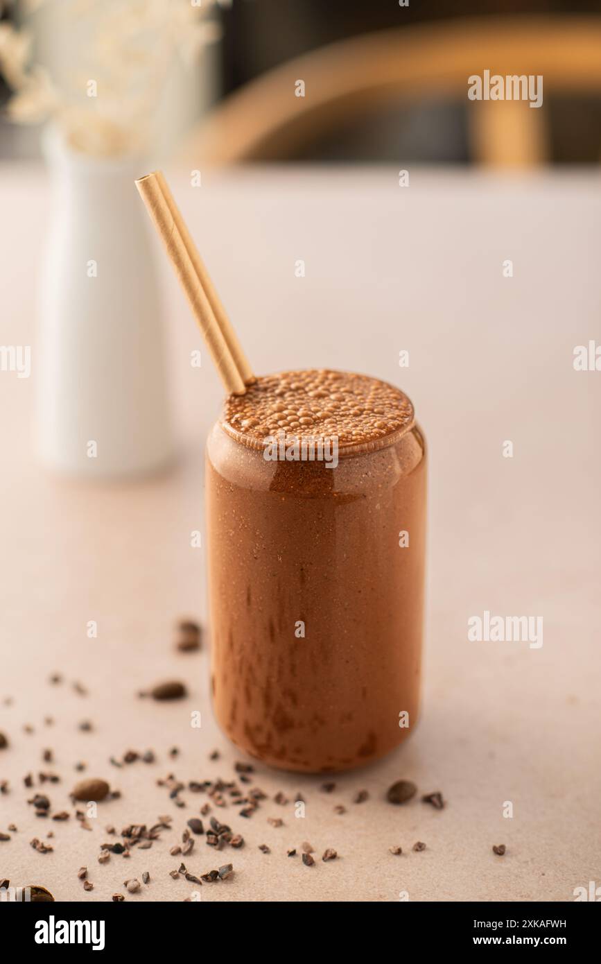 Chocolate smoothie on a coffee shop table. Vegan smoothie, healthy drink. Stock Photo