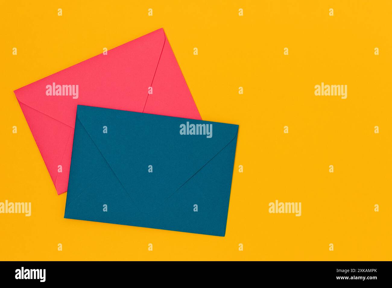 Multicolored envelopes on a yellow background. Composition with place for text. Stock Photo