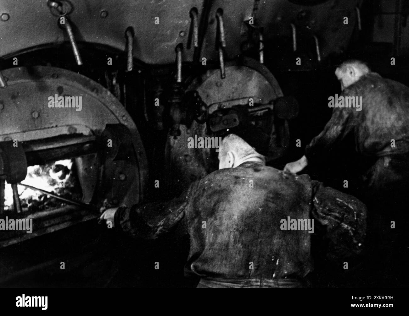 Stoker in the boiler room of a German warship. Photo: Berndt. [automated translation] Stock Photo