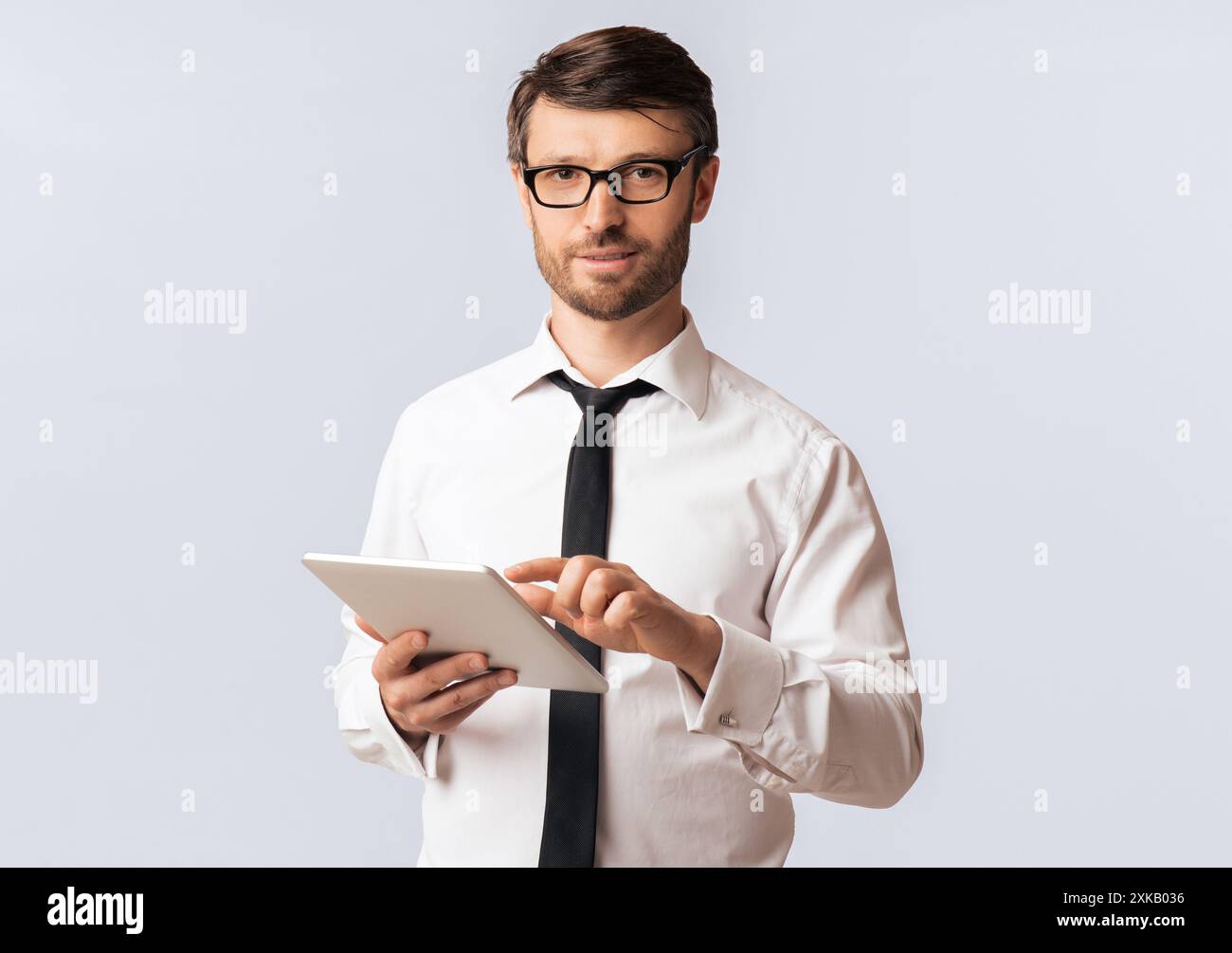 Man in White Shirt Using Tablet Stock Photo