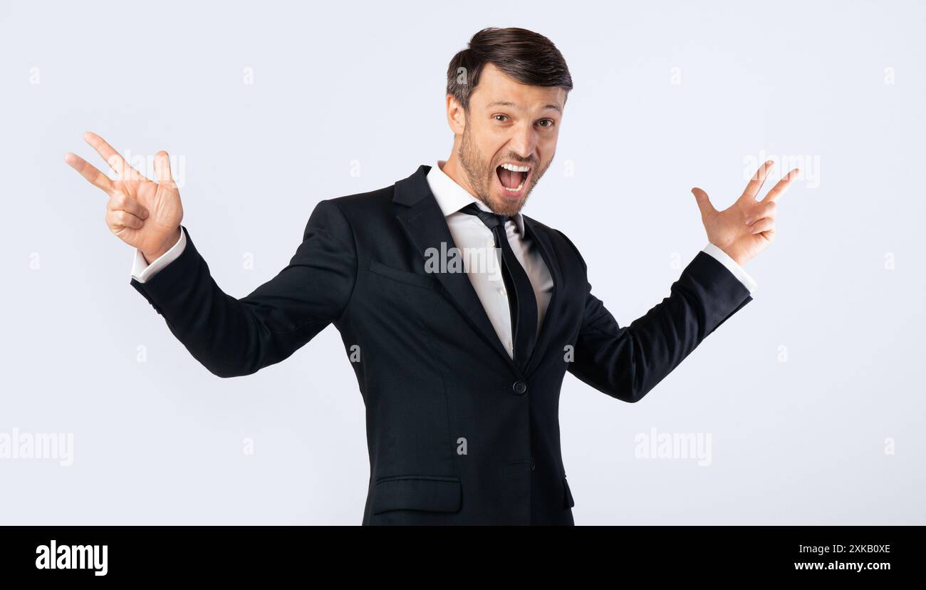 Excited Man Shouting Spreading Hands Standing On White Background Stock Photo