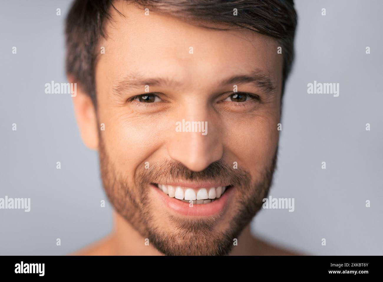 Man Smiling With Brown Hair and Beard Stock Photo