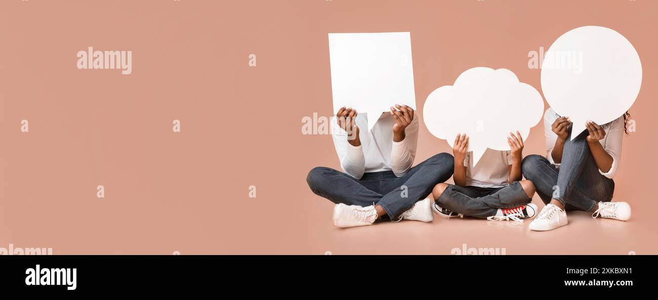 Empty speech bubbles in hands of african american family Stock Photo