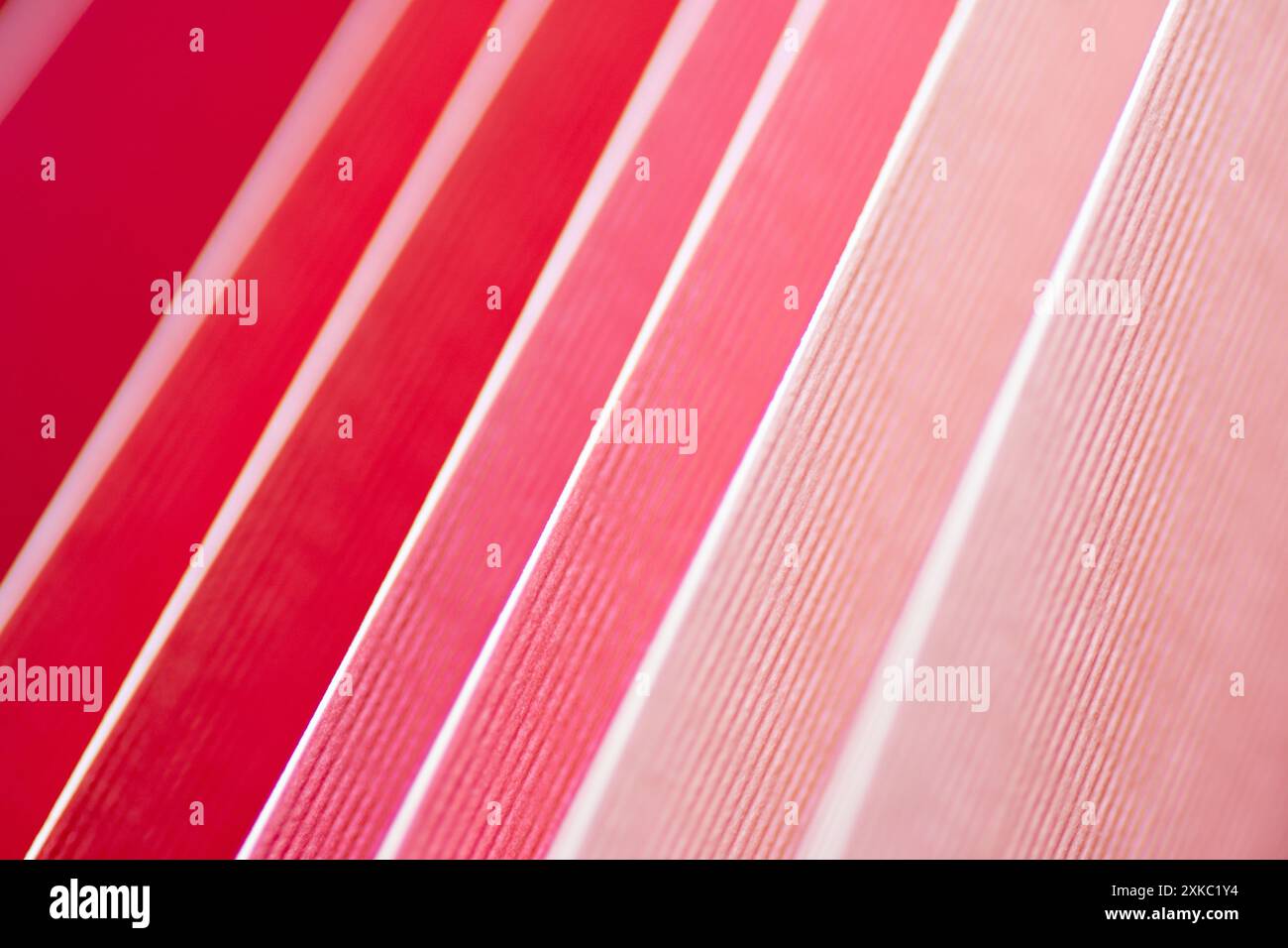 A sample of cardstock colors in red and pink in a color gradient. Stock Photo