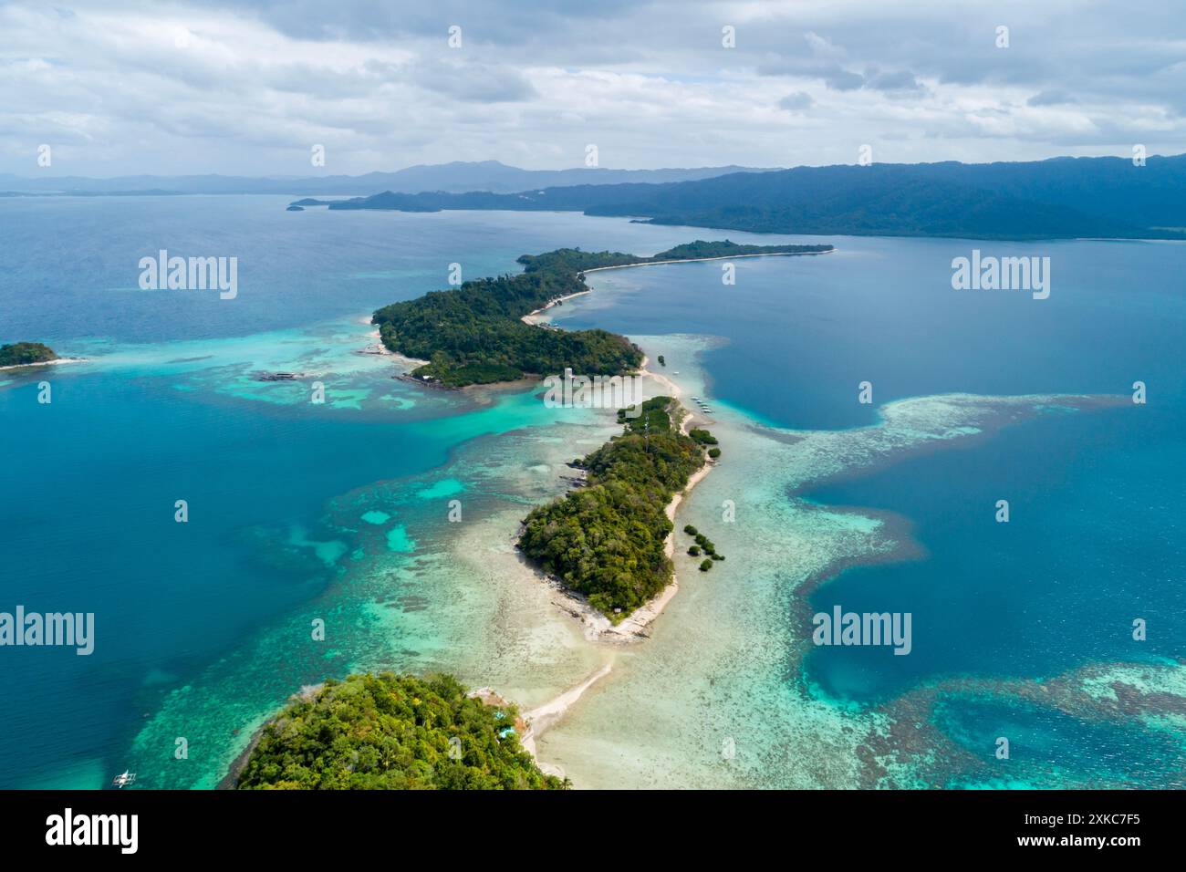 Aerial view of lush green islands surrounded by clear blue waters in ...
