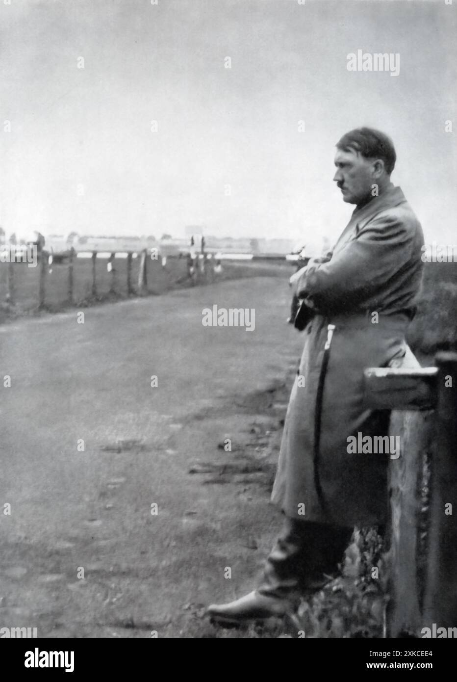 A photograph of Adolf Hitler in 1932, showing him in solitary contemplation during his rise to power. At this time, Hitler was the leader of the National Socialist German Workers' Party (NSDAP), and he was on the path to establishing the Greater German Reich. His political maneuvers during this period would soon lead to his appointment as Chancellor of Germany in 1933, marking the beginning of the Nazi regime. Stock Photo