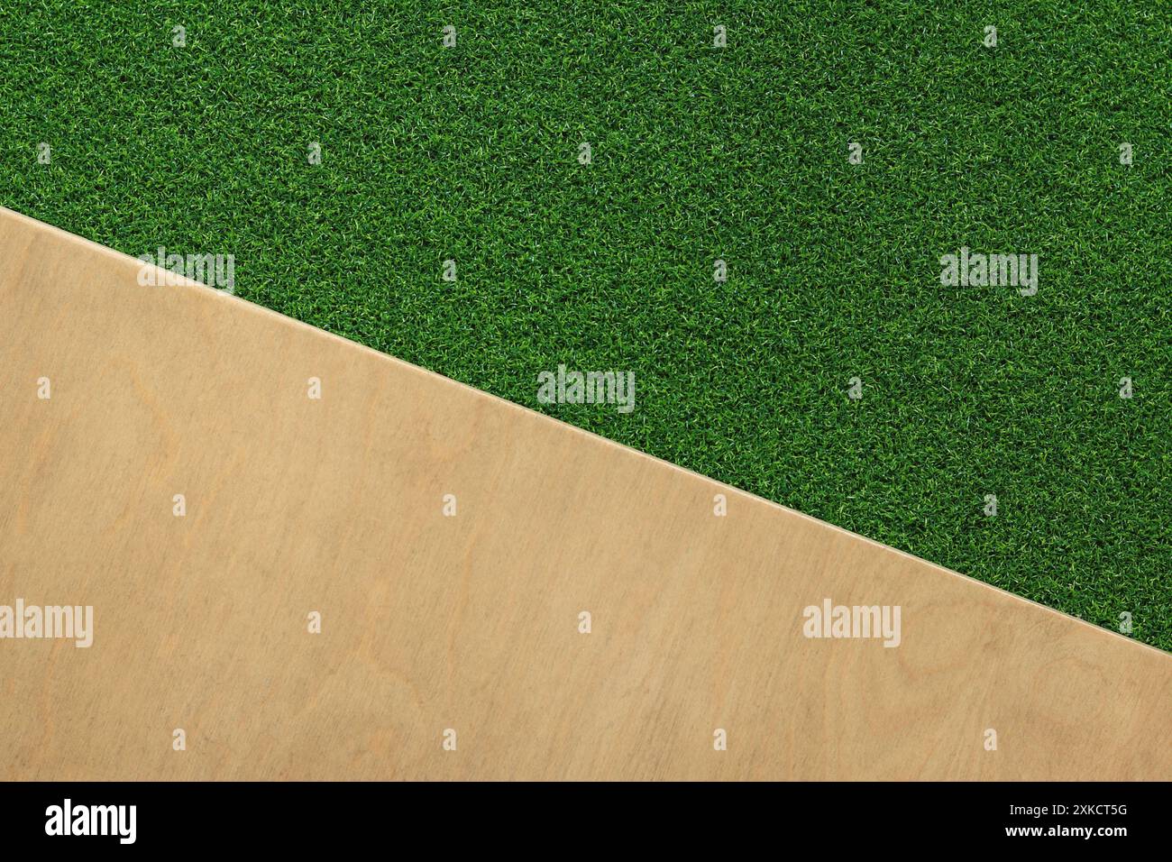 Green artificial grass rug on a wooden background. Artificial grass ...