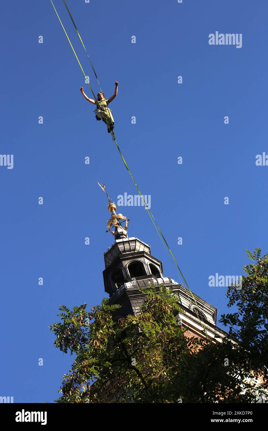 Cracow. Krakow. Poland. Young female aerialist performing tightrope show over the Old Market Place. Street Theatre Festival. International annual even Stock Photo