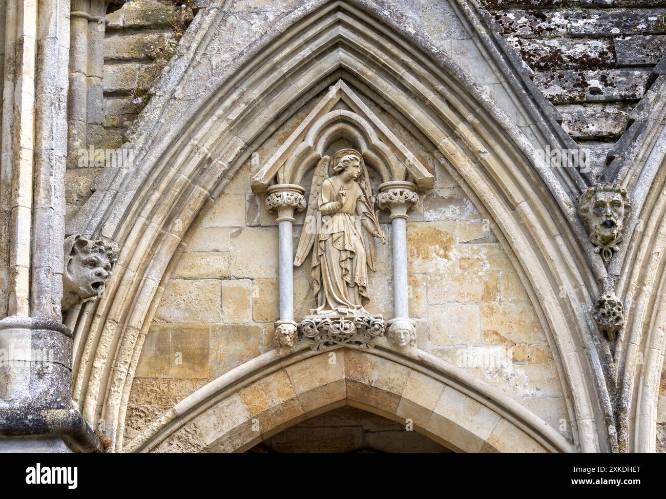 Angel sculpture and gargoyles over doorway into Salisbury Cathedral