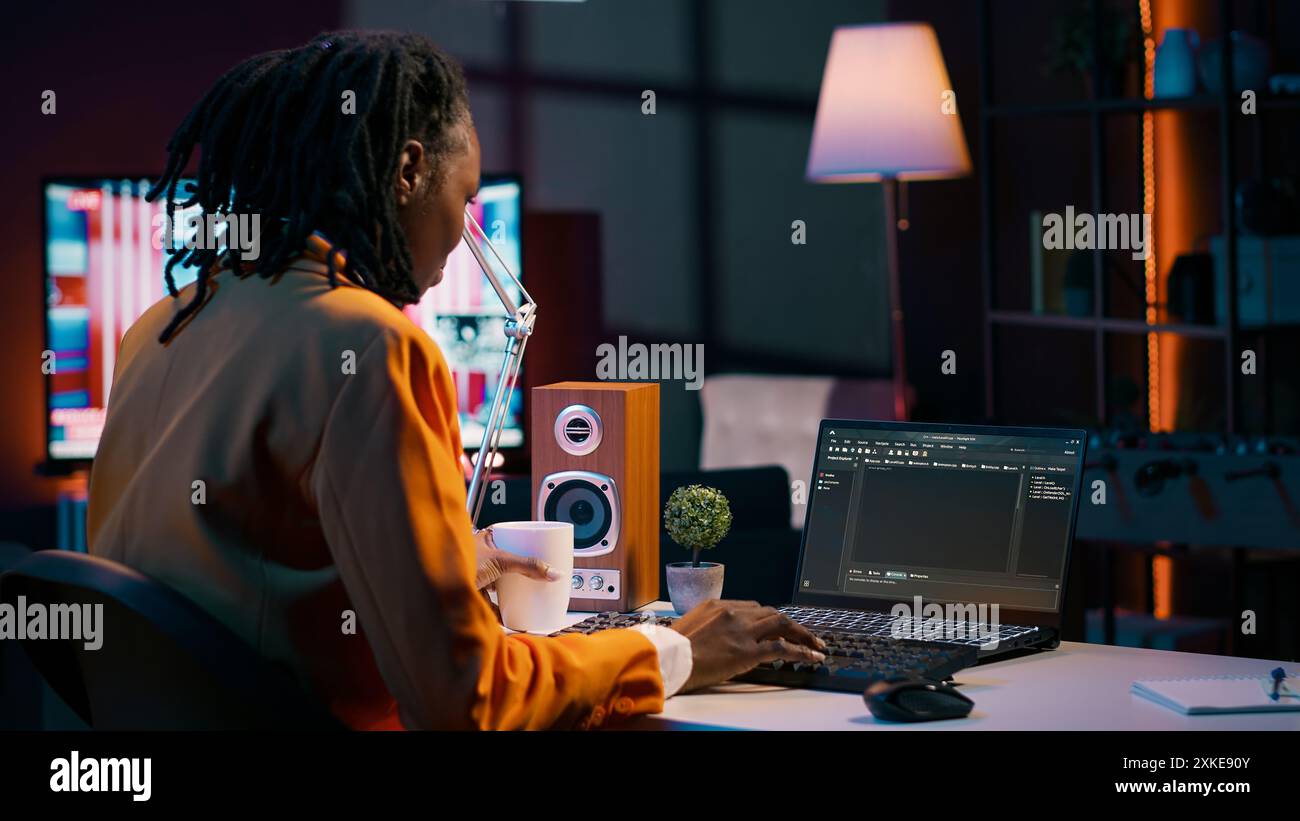 African american IT student practicing coding or programming exercises, learning hardware language and system debugging. Young woman studying database script on html window. Camera A. Stock Photo