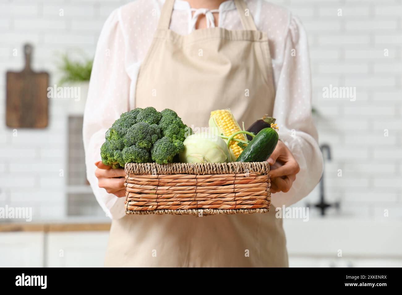 Pregnant woman holding wicker basket with different fresh vegetables in ...