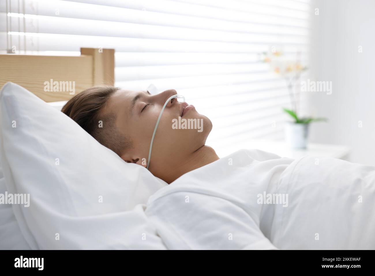 Coma patient. Young man sleeping in hospital bed Stock Photo - Alamy