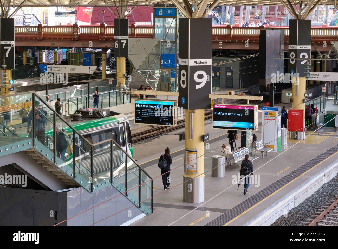 Perth Railway station with commuters on the platforms. A train is at Platform 8. Its route