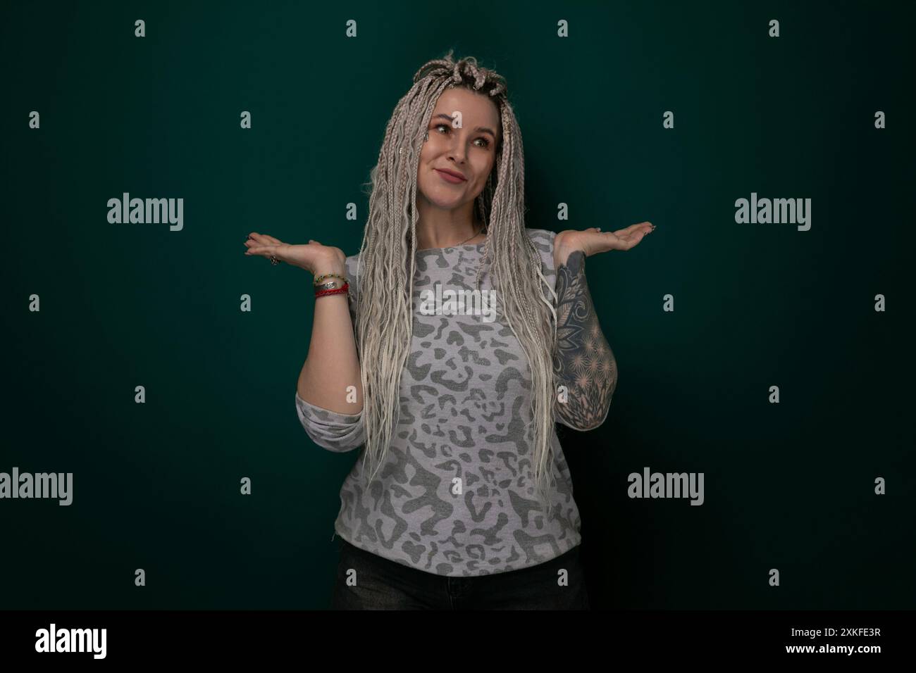 Woman With Long Blonde Hair Standing in Front of Green Wall Stock Photo ...