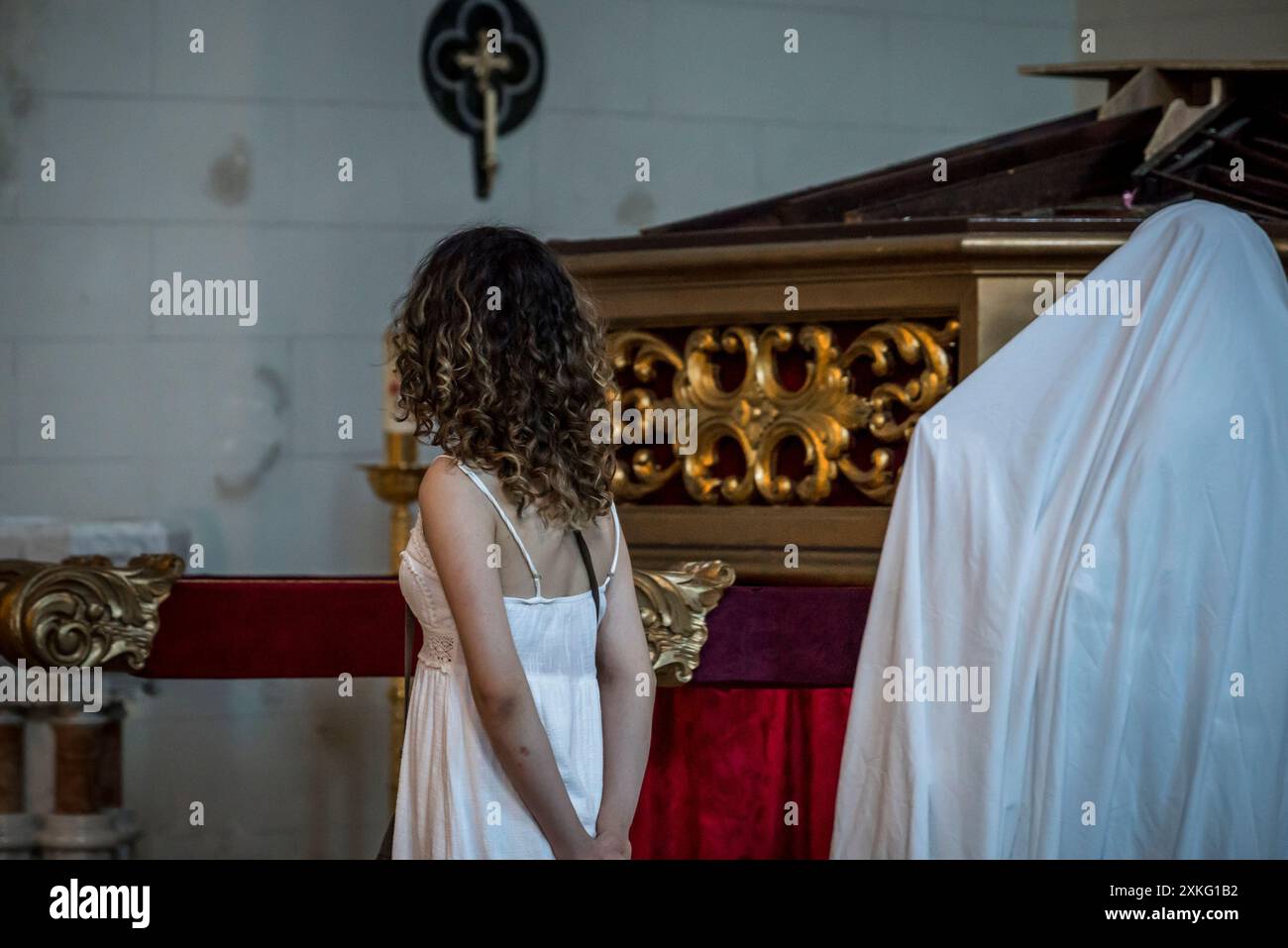 Woman and statue covered in white sheet in a church, Panama City, Panama, Central America Stock Photo