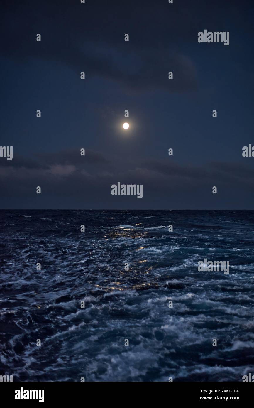 Full moon in the sky over the sea with waves at night Stock Photo - Alamy