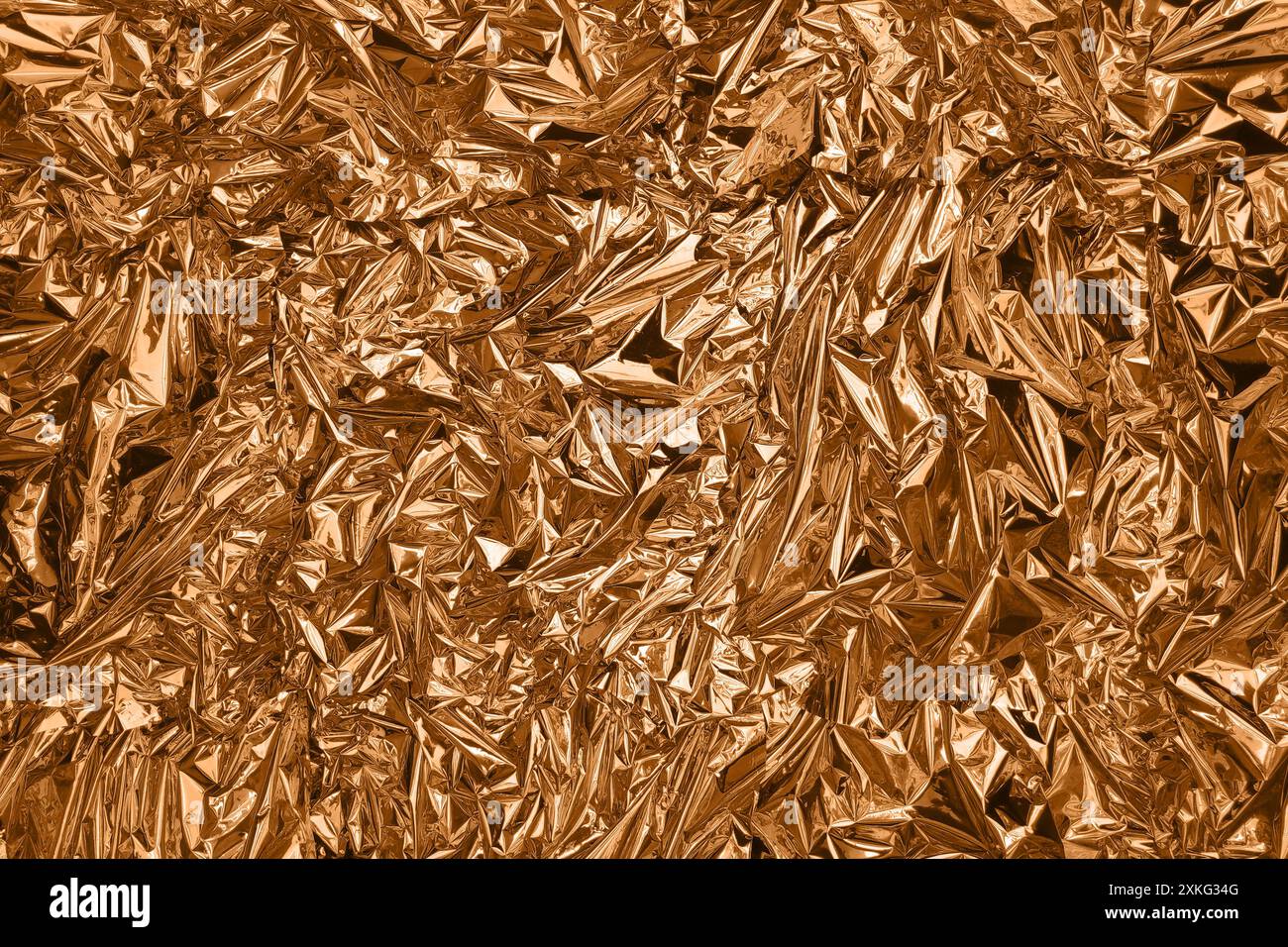 Fullframe crumpled copper foil shining texture background. Stock Photo