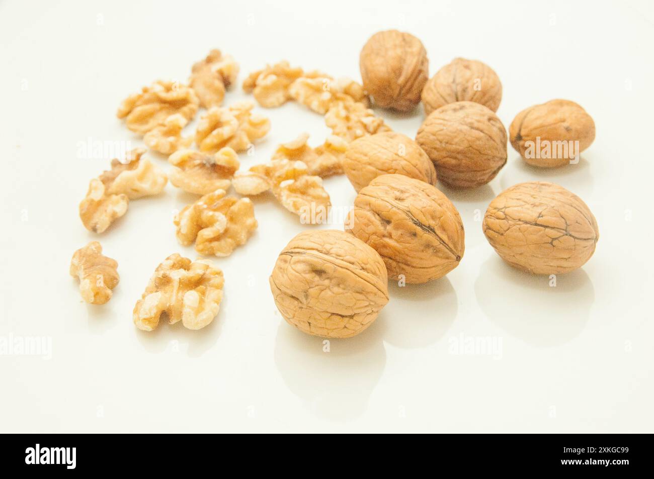 walnuts with and without shell, on white background. Stock Photo