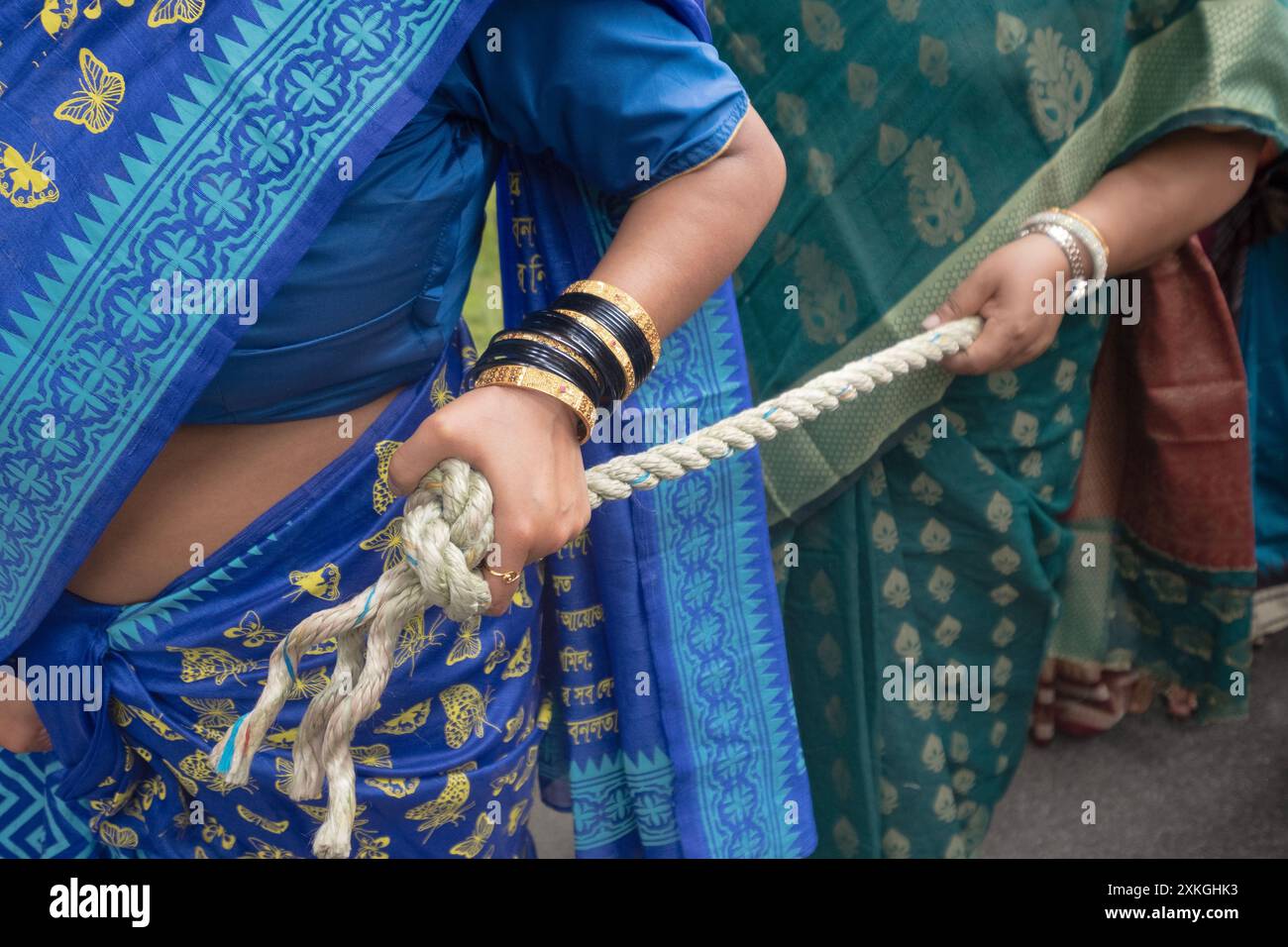 A close up of Hindu women holding rope that will be used by dozens of people to pull a chariot during the 2024 Ratha Yatra in Wilton, Connecticut. Stock Photo