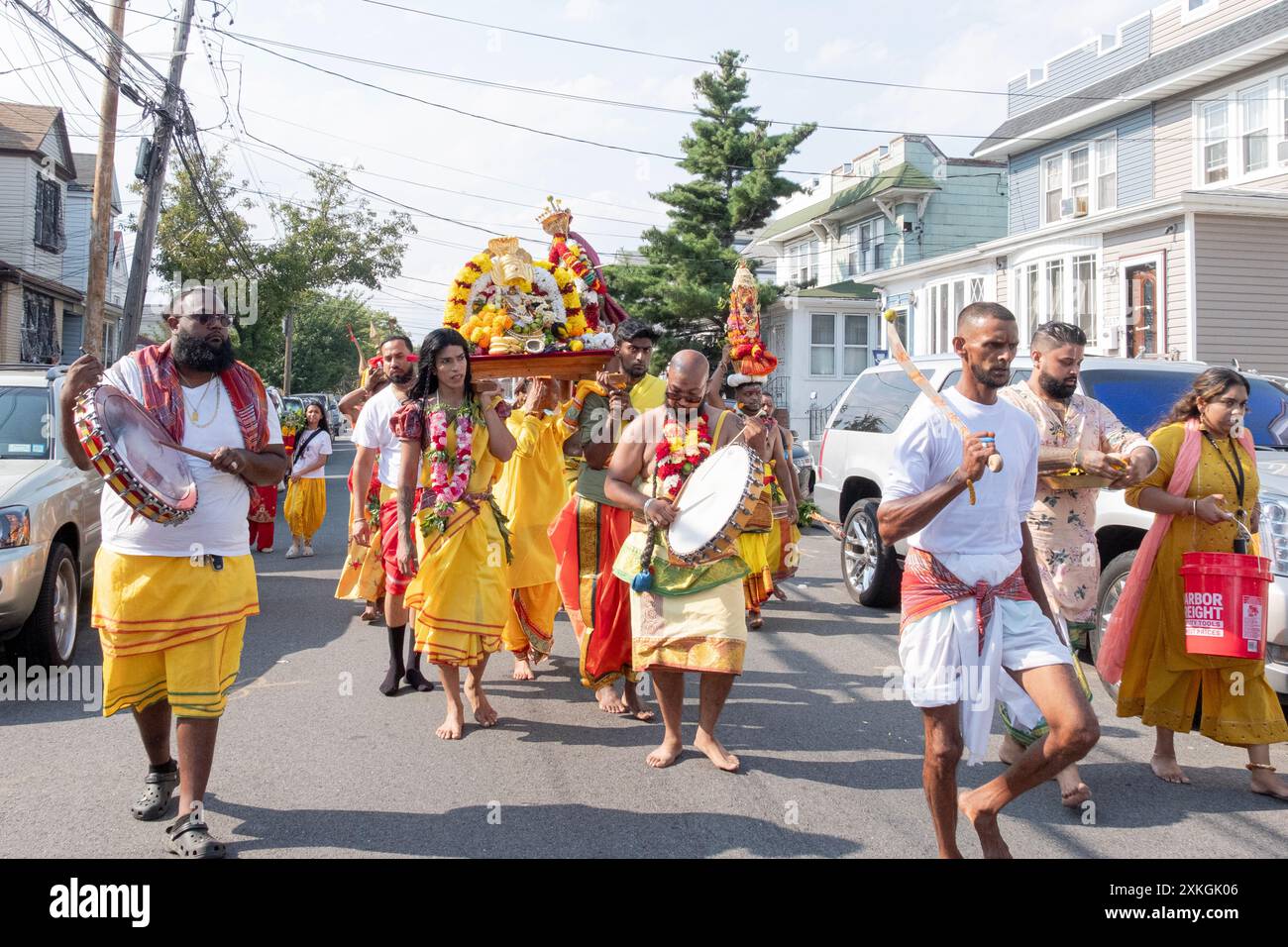 Devout Hindu worshippers march to the Arya Spiritual Grounds for the Thimithi ritual of walking on hot coal. In Jamaica, Queens, New York. Stock Photo