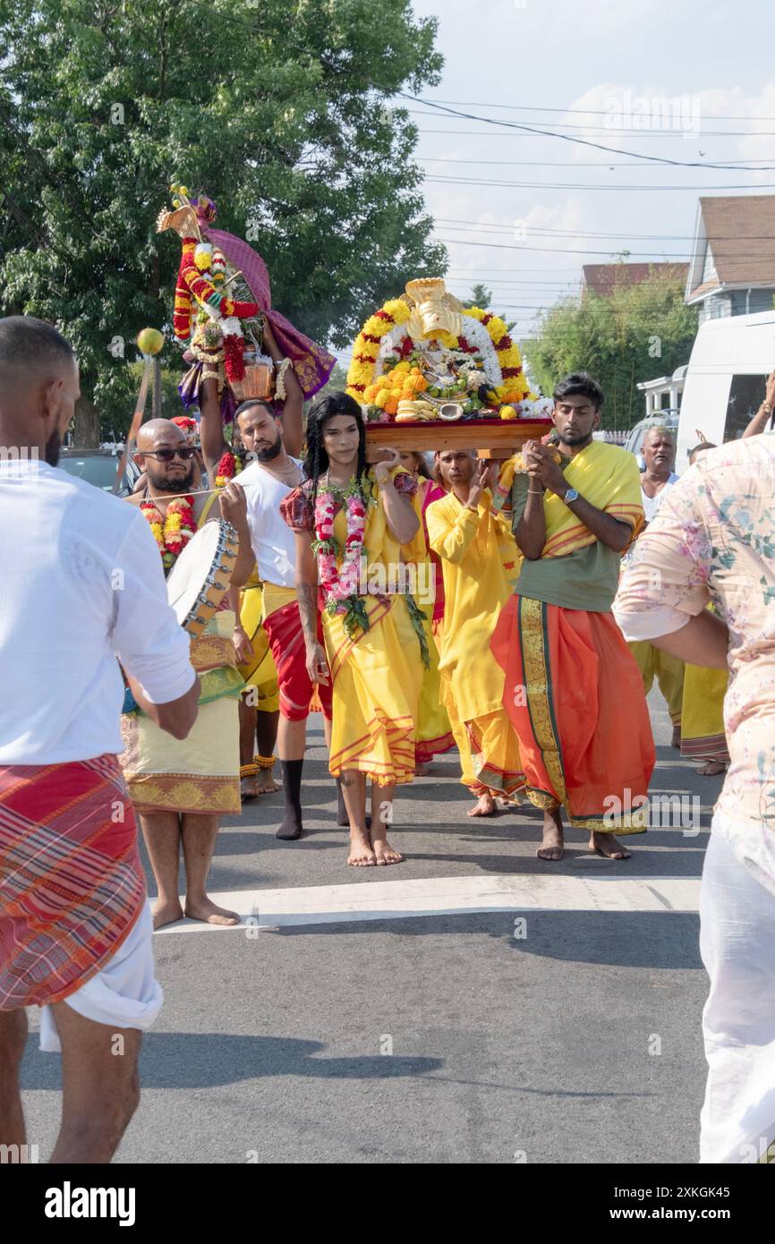 Devout Hindu worshippers march to the Arya Spiritual Grounds for the Thimithi ritual of walking on hot coal. In Jamaica, Queens, New York. Stock Photo