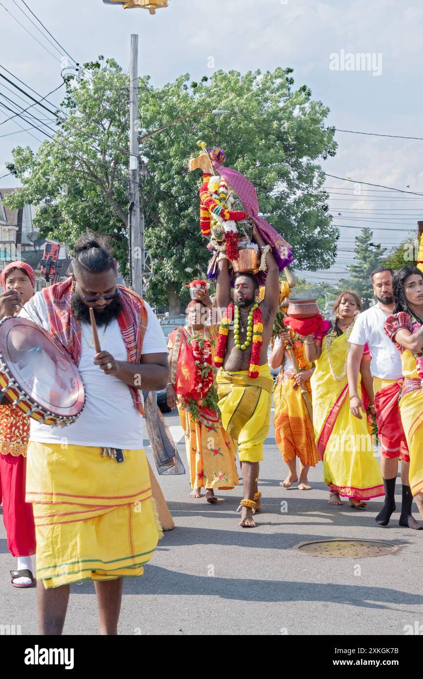 Devout Hindu worshippers march to the Arya Spiritual Grounds for the Thimithi ritual of walking on hot coal. In Jamaica, Queens, New York. Stock Photo