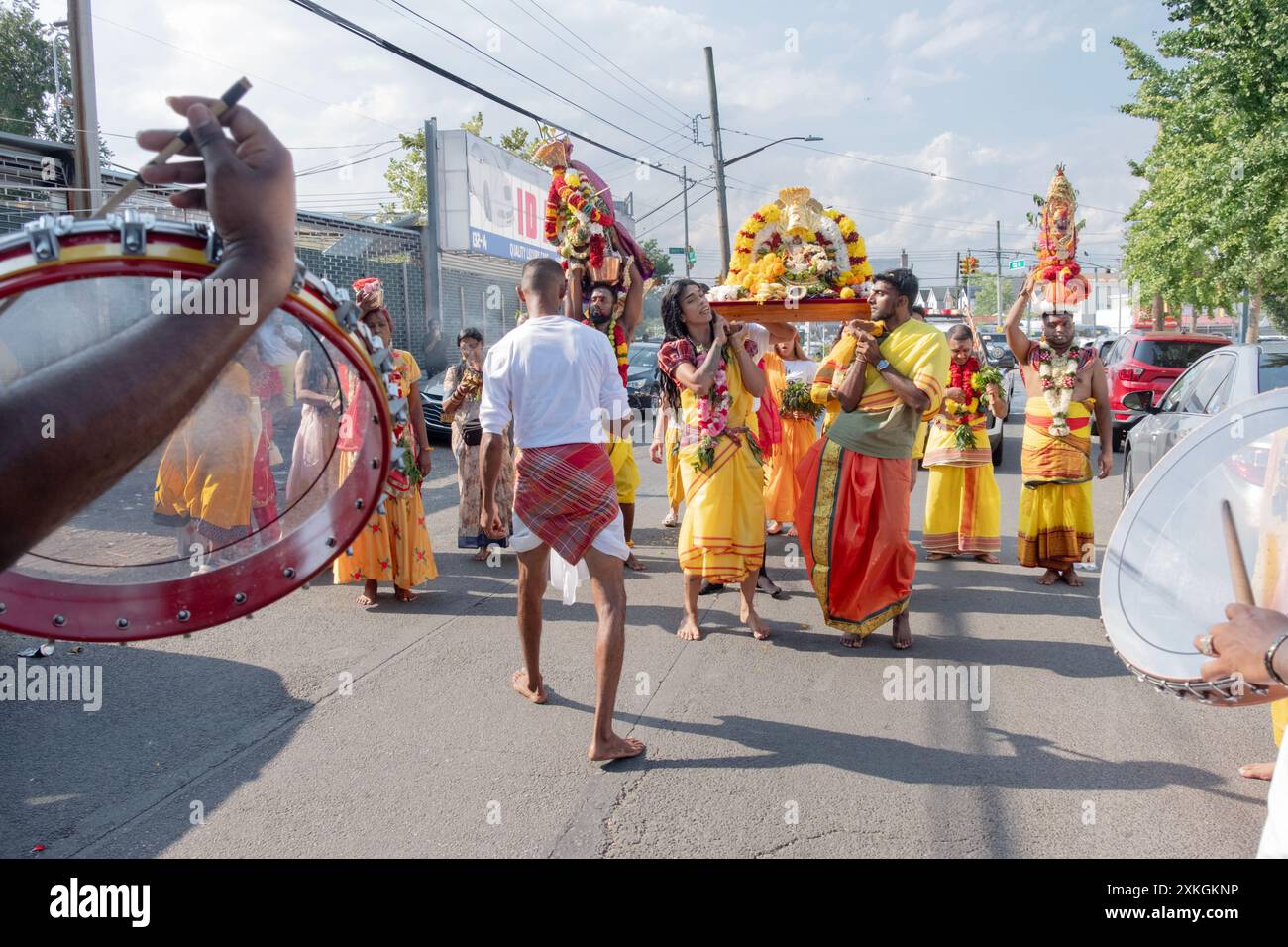 Devout Hindu worshippers march to the Arya Spiritual Grounds for the Thimithi ritual carry a statue of goddess Kali. In Queens, New York. Stock Photo