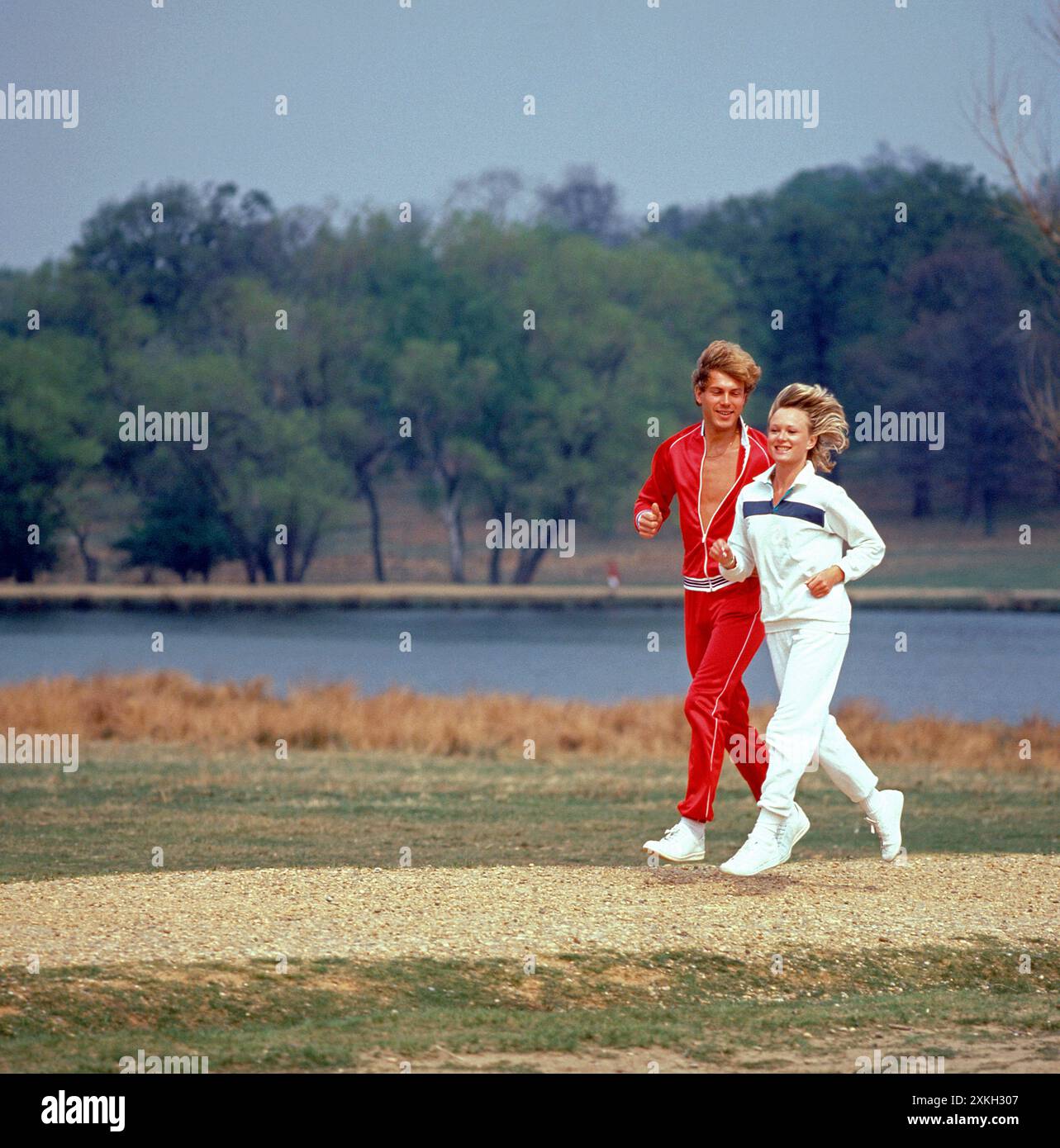 Young couple running in a park. Stock Photo