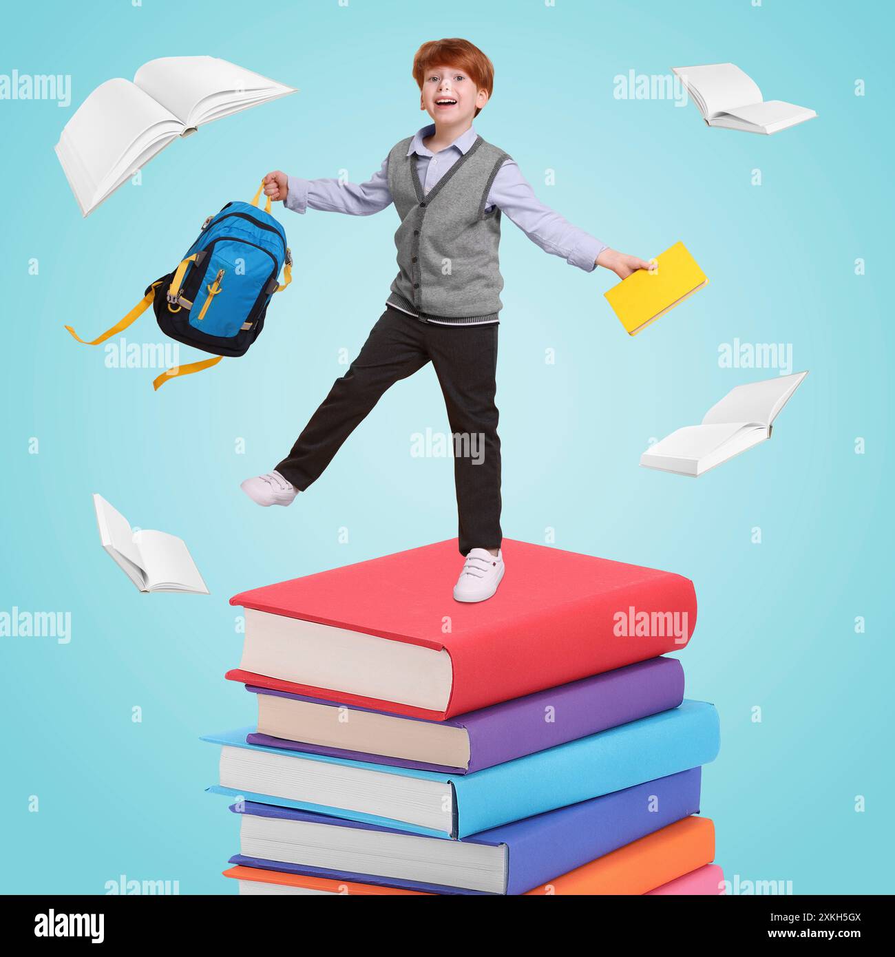 Happy schoolboy with backpack and textbook on stack of books against ...