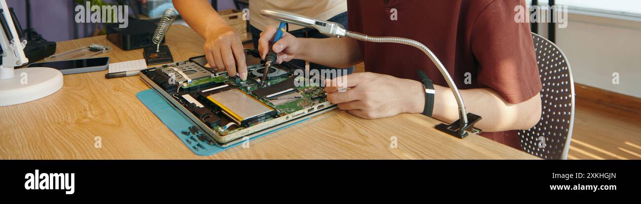 Colleagues Working With Broken Computer In Team Stock Photo