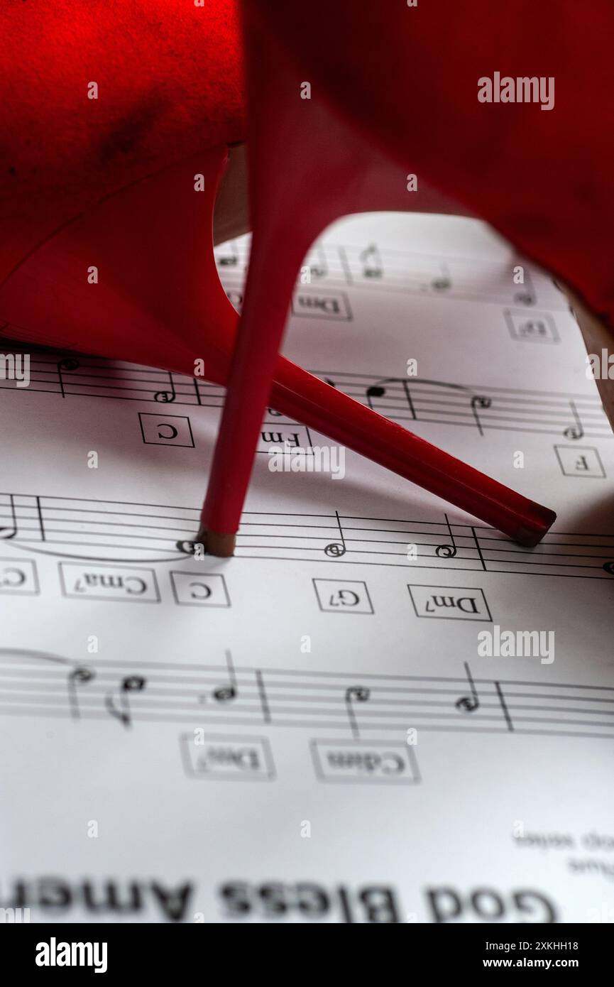 red high heeled shoes and sheet music Stock Photo