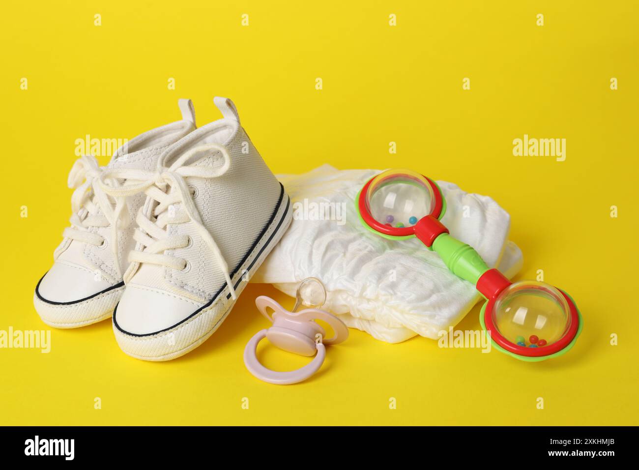 Yellow Babay Rattle Baby rattle and accessories on yellow background Stock Photo - Alamy