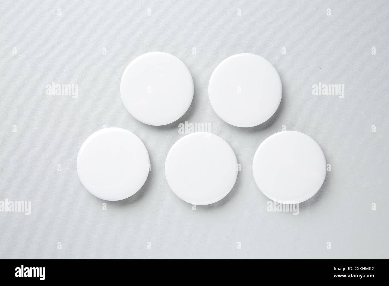 Blank white button badges on light background, flat lay. Mockup for design Stock Photo
