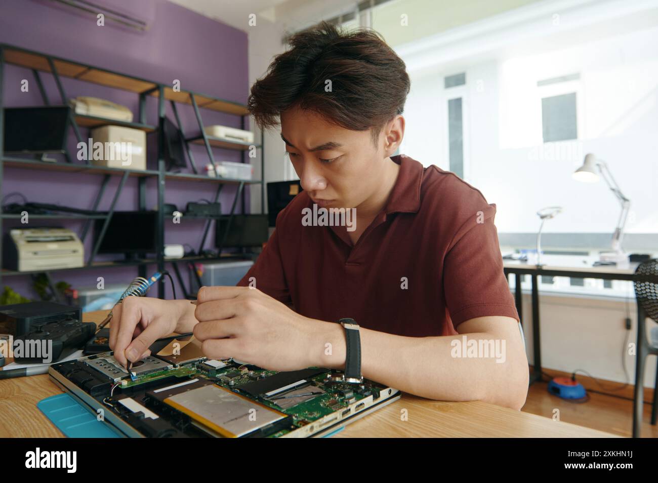 Master Working With Broken Laptop In Workshop Stock Photo