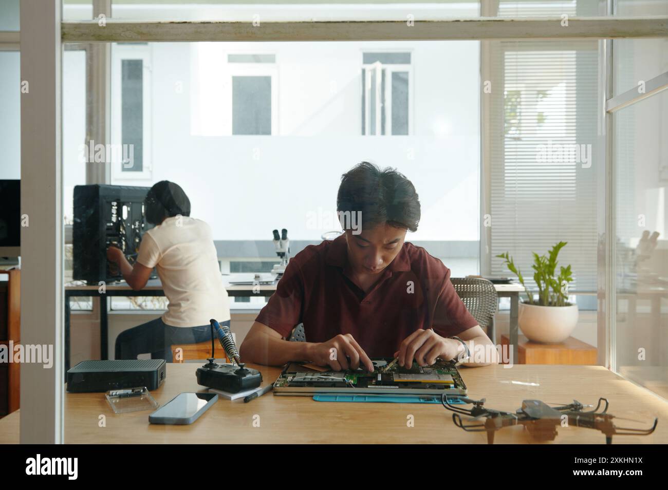 People Working In Computer Repair Service Stock Photo