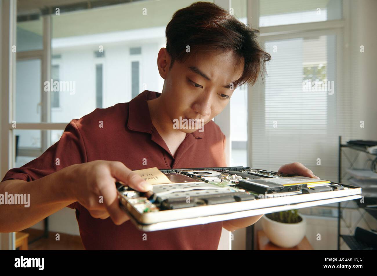 Engineer Working With Broken Laptop Stock Photo