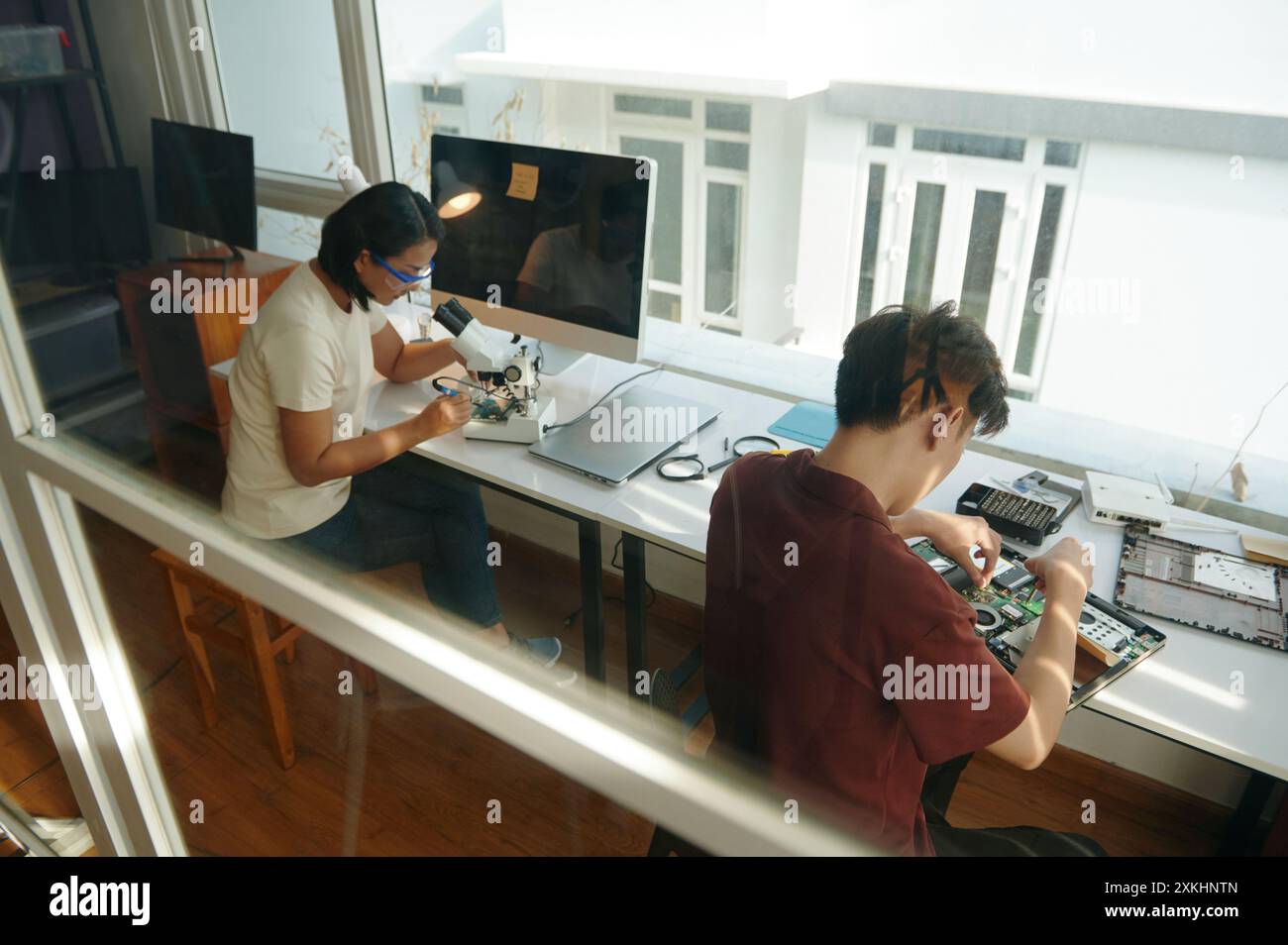 Colleagues Repairing Gadgets In Workshop Stock Photo