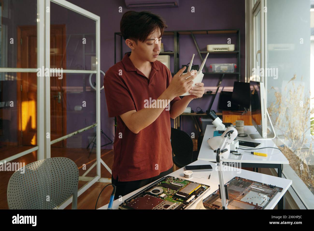 Technician Repairing Router In Workshop Stock Photo - Alamy