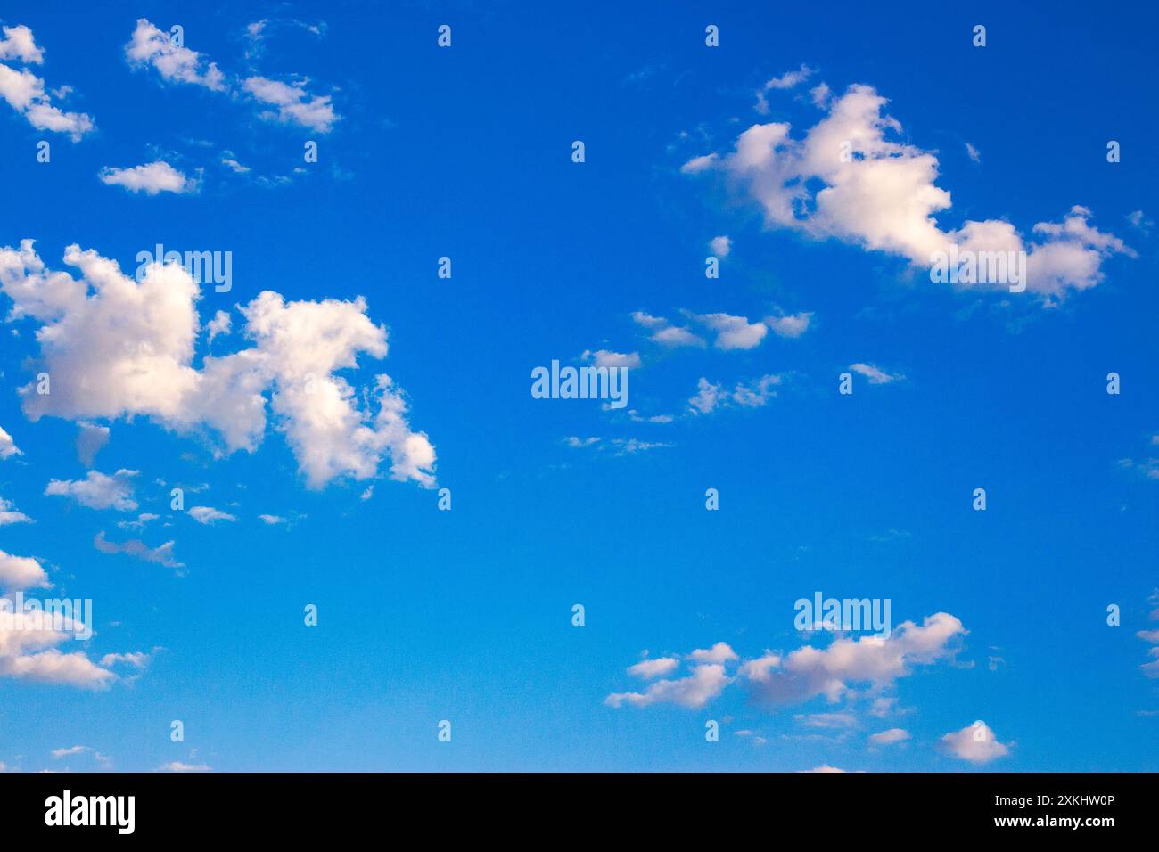 white fluffy clouds on the blue sky in summer. bright sunny weather forecast Stock Photo