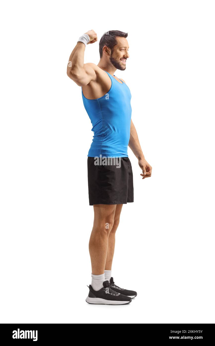 Fit man in sportswear flexing arm muscle isolated on white background Stock Photo