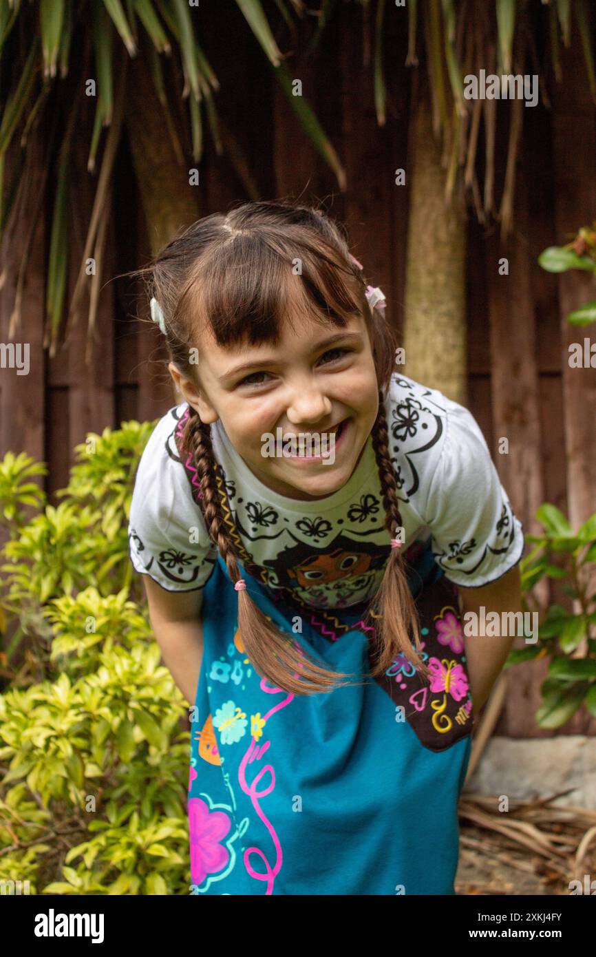 portrait of a little child girl smiling in front of tree Stock Photo ...