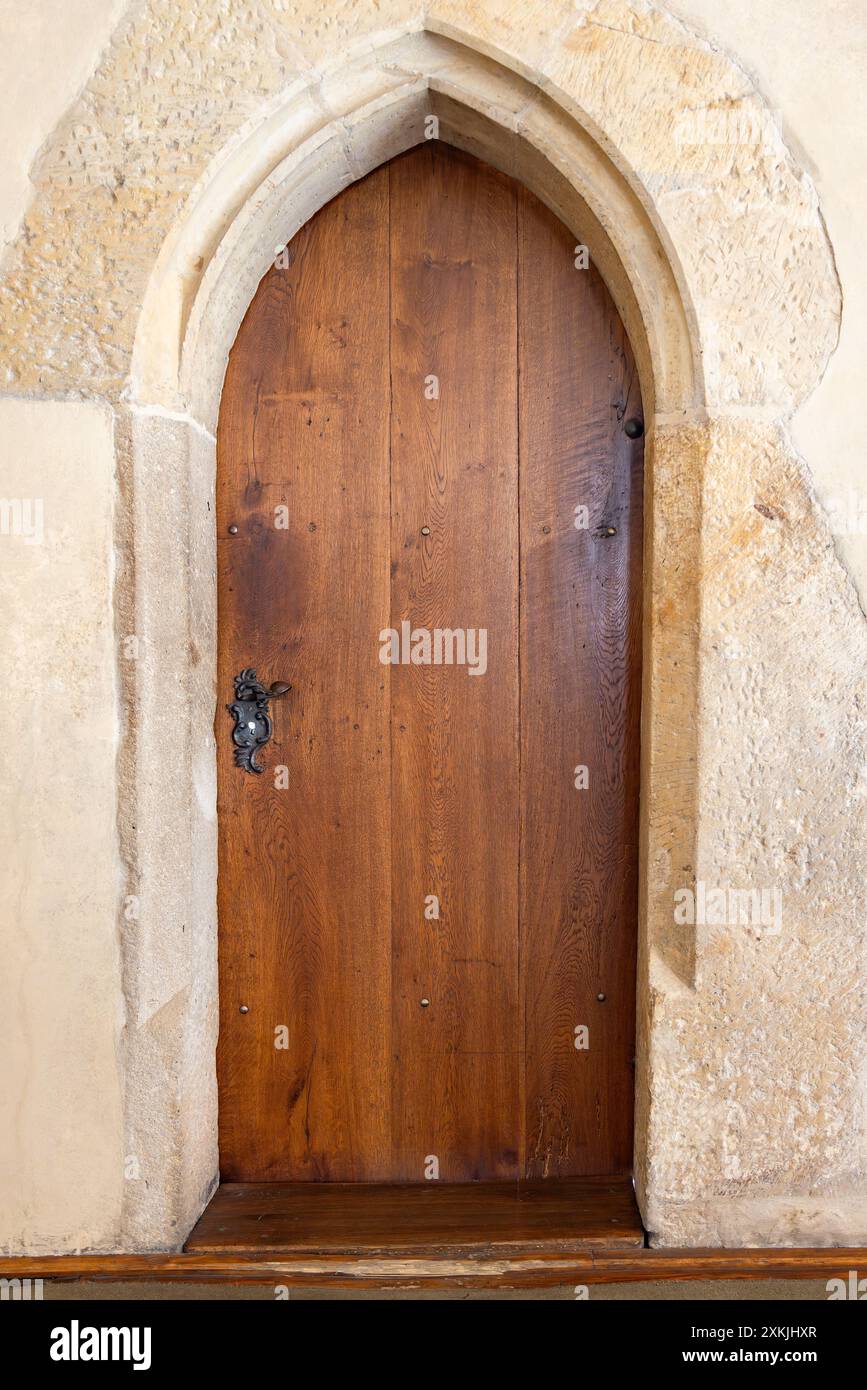 Old wooden door with ornaments in a stone wall, usually used in ...