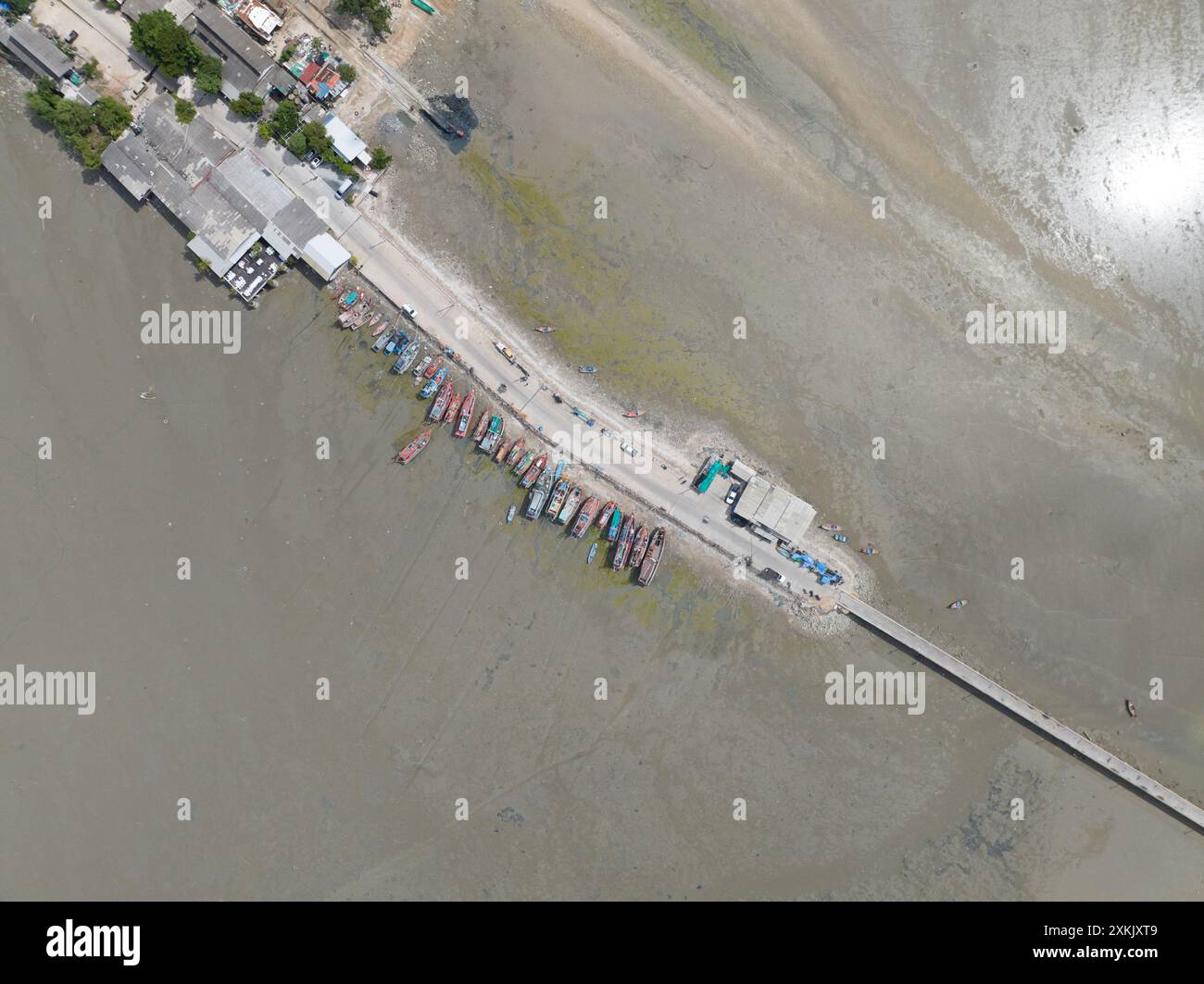 Stranded and docked fishing ship in Thailand. Low water Stock Photo - Alamy