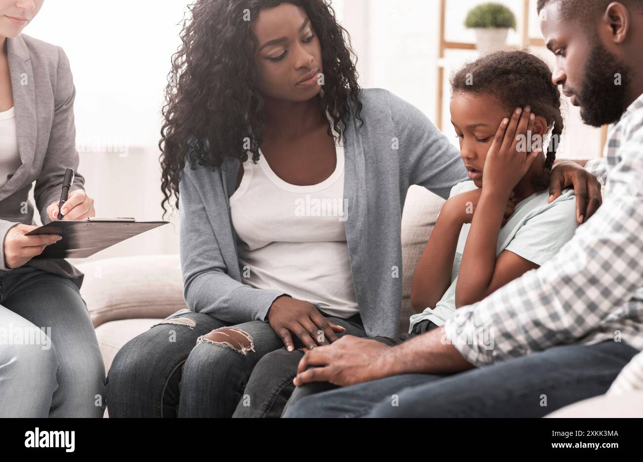 Little black girl and her parents at psychologist consultation Stock ...