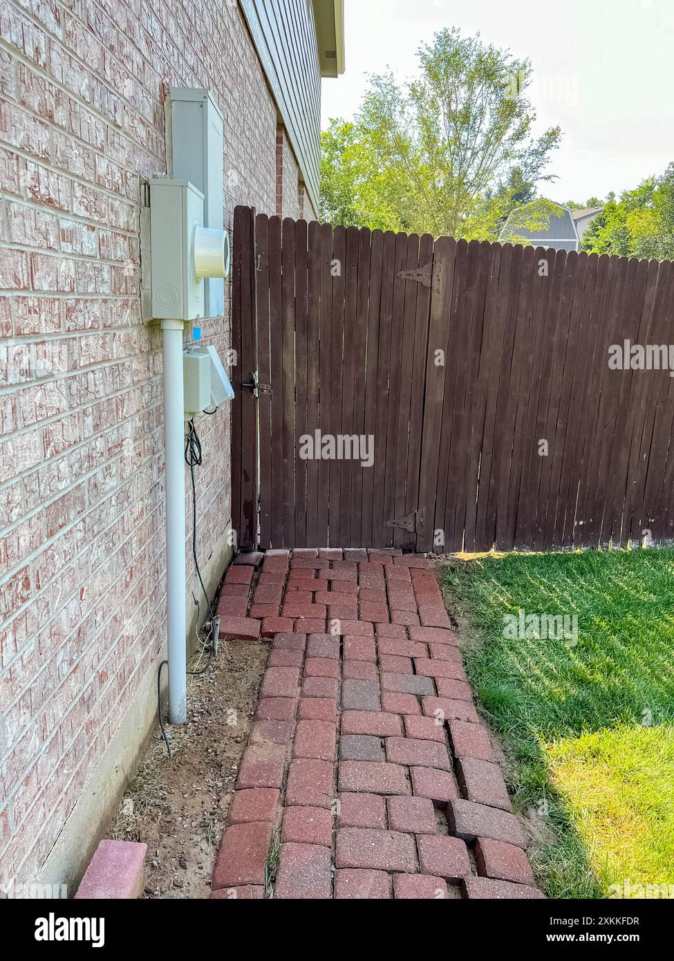 Backyard Fence and Brick Pathway Next to Brick House Stock Photo - Alamy